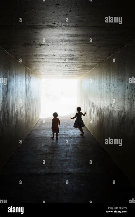 Silhouettes Of Children In Tunnel Stock Photo Alamy