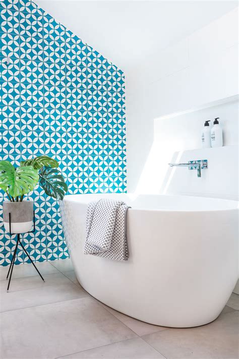 This White And Wood Bathroom Has A Bright Blue Accent Wall To Liven It Up