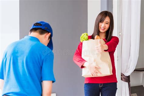 Delivery Man Making Grocery Service Giving Fresh Vegetables In Paper