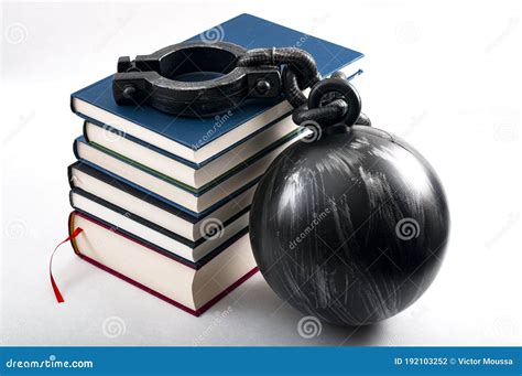 Student Debt Concept With A Stack Of Books Next To A Ball And Chain