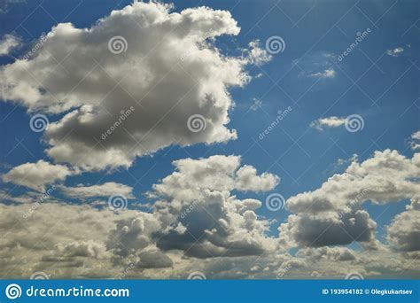 Fluffy Cumulus Clouds Are Flying High Up In The Daylight Blue Sky Stock