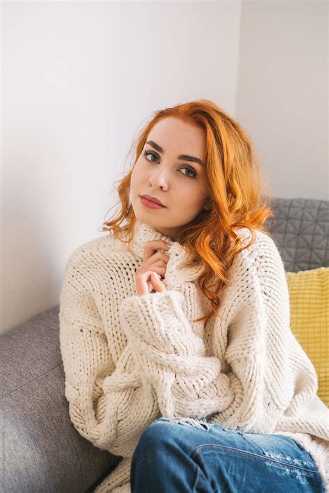 portrait of beautiful redhead woman weraing white sweater at home by stocksy contributor