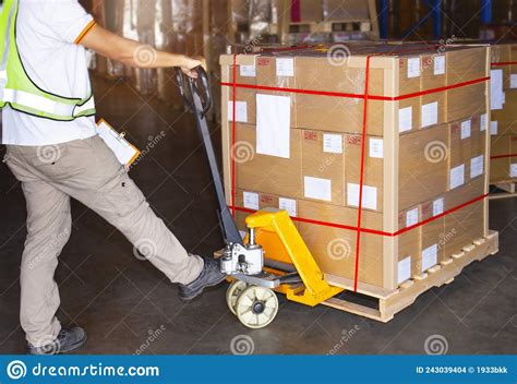 Workers Using Hand Pallet Jack Unloading Packaging Boxes In Storage Warehouse Delivery Shipment