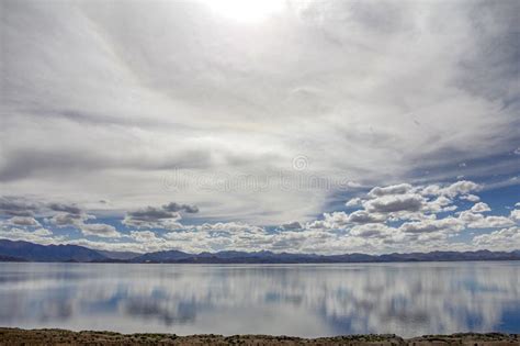 The Calm Lake Reflects The Blue Sky And Beautiful White Clouds Stock