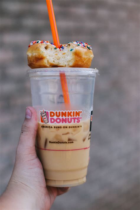 My home state of rhode island boasts the highest ratio of dunkin' donuts per square mile, so you could say it's a bit of an institution. dunkin' donuts' on top of iced coffee cup and orange straw free image | Peakpx