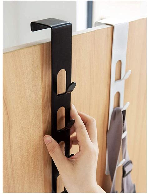 A Person Is Holding The Door Handle On A Wooden Paneled Wall With Metal