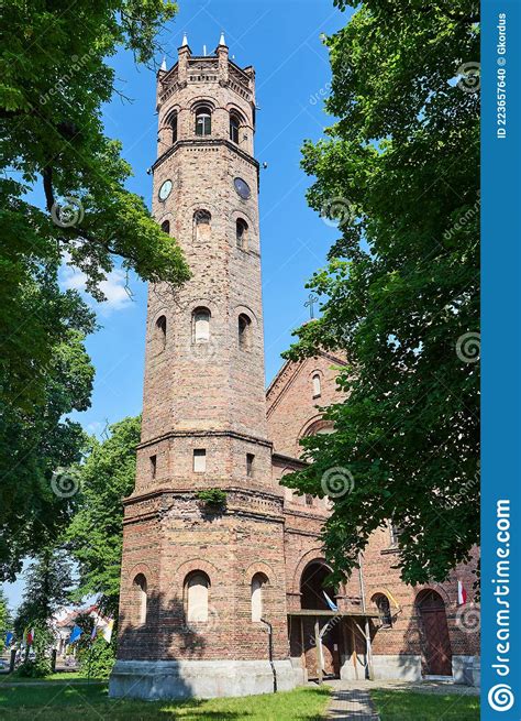 The Historic Tower Of The Gothic Red Brick Church In The City Of