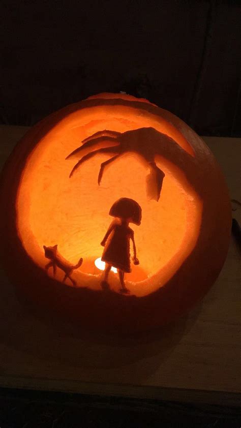 A Carved Pumpkin With An Image Of A Person Holding An Umbrella And Two