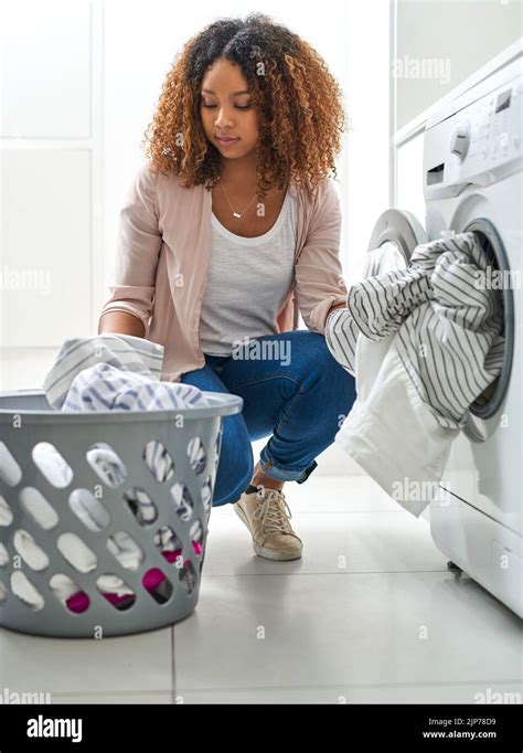 Its A Chores Type Of Day A Young Attractive Woman Doing Laundry At