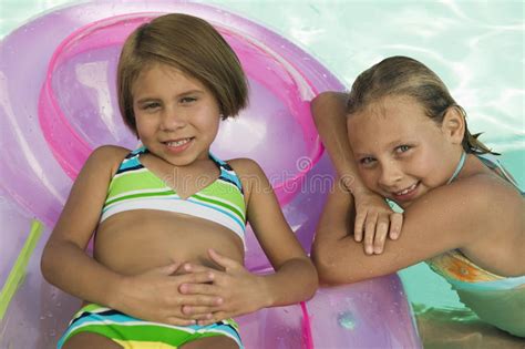 Portrait Of Two Girls In Swimming Pool Stock Image Image Of Airbed