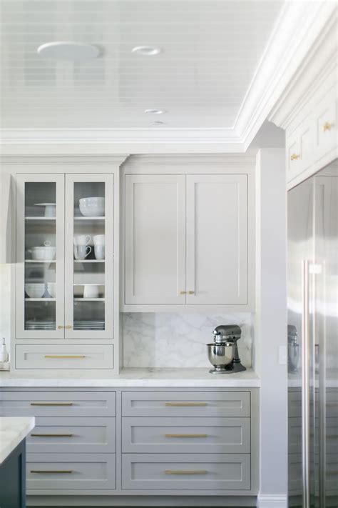 Using cream cabinets in your kitchen is a great choice because it brightens up the space. Gorgeous light grey cabinets, marbled countertops ...