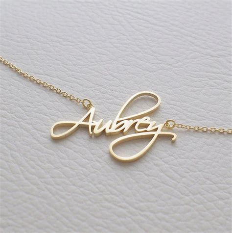 A Gold Necklace With The Word Always Written On It