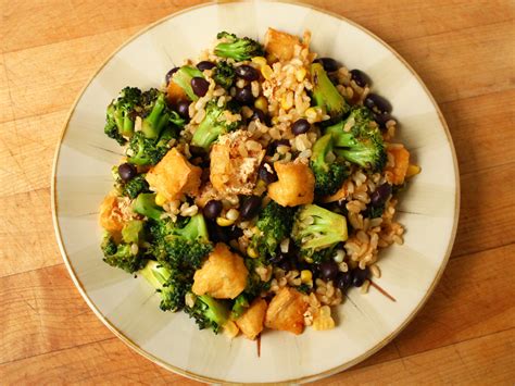 Add the ginger, garlic and spring onions and cook for a minute then add the rice wine, soy sauce, chilli garlic sauce and stock and bubble everything together, add more stock if you need to. Brown rice cooked in vegetable stock, black beans,... | Garden of Vegan