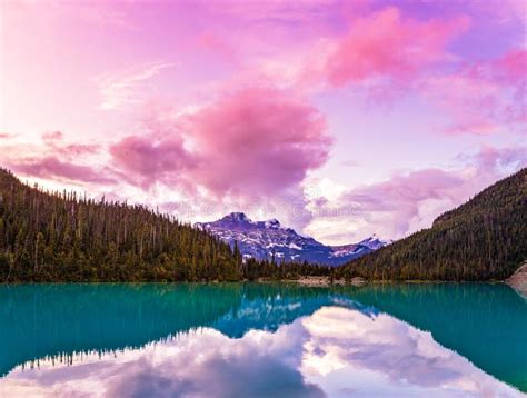 Pink Clouds Over A Mountain Sunset Reflected In The Lake Lake Stock