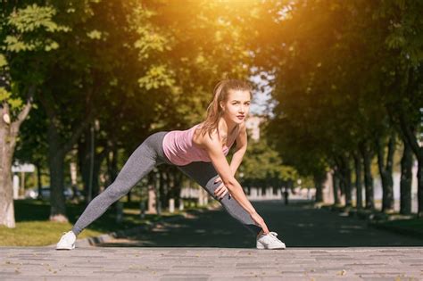 Fit Fitness Woman Doing Stretching Exercises Outdoors At Park Free Photo