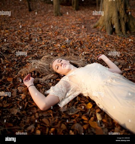 Asleep On The Ground A Slim Blonde Woman Girl Alone In Woodland