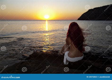 Naked Woman Sitting On Floor With Crossed Legs Royalty Free Stock Image