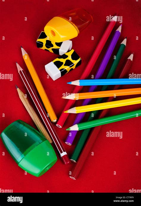 Colored Pencils Erasers Sharpeners Isolated On Red Background Stock
