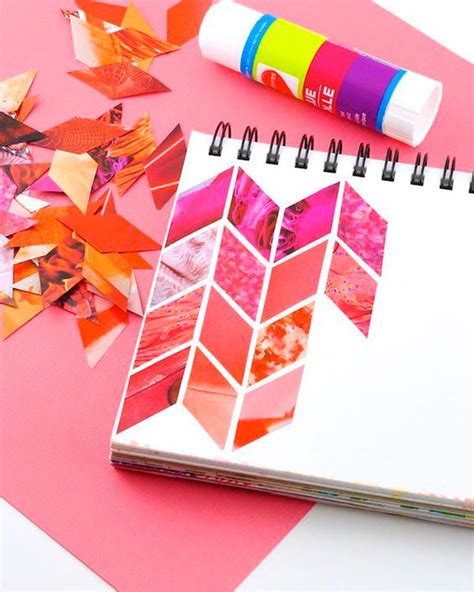 An Open Notebook With Colorful Papers And Crayons Next To It On A Pink