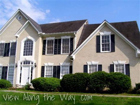 I just can't get past the screen door and shutters are black. House Exterior: Beige with Black shutters and black roof ...