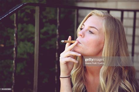 Confident Beautiful Woman Smoking Cigarette High Res Stock