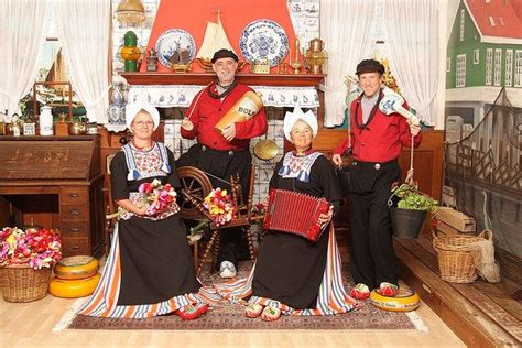 Three Men And Two Women Dressed In Folk Costumes