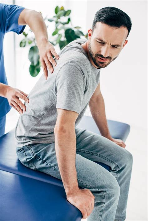 Chiropractor Massaging Back Of Good Looking Man Stock Image Image Of Caucasian Chiropractic