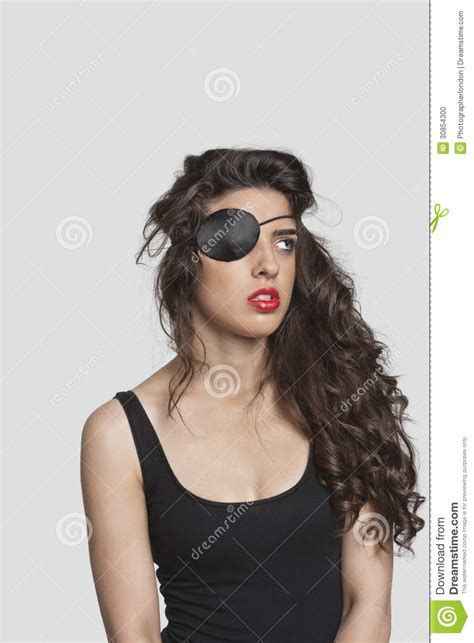 Thoughtful Young Woman Wearing Eye Patch Over Gray