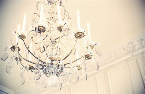 A Chandelier Hanging From The Ceiling In A Room With White Walls And