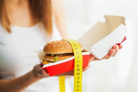 Diet And Fast Food Concept Overweight Woman Standing On Weighin Stock