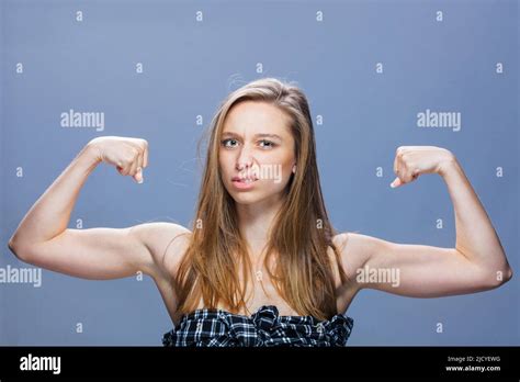 Skinny Brunette Girl Showing Muscles With Angry Face Expression Studio