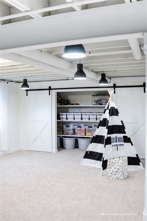A Black And White Teepee Tent Sitting In The Middle Of A Room