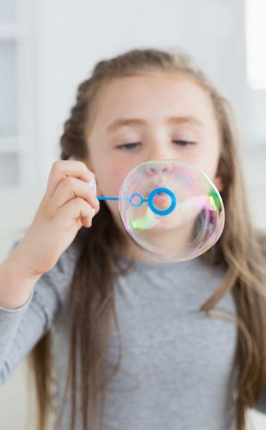 premium photo girl blowing bubbles
