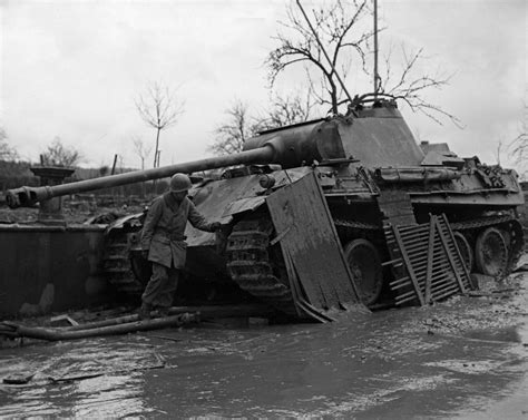 A Us Soldier Inspecting A Damaged German Mark V Panther Tank Kelberg