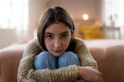 Teenage Girl Sitting On The Floor With Head On Her Knees Koncept Of Mental Health Stock Photo