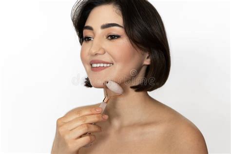 Beautiful Brunette A Smooth Skin Using Derma Roller For Her Face Stock