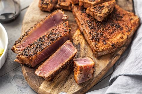Add seasoned tuna and poach until mostly opaque but still a little pink in the center, about 4 minutes per side. Spice-Rubbed Seared Ahi Tuna Steaks Recipe