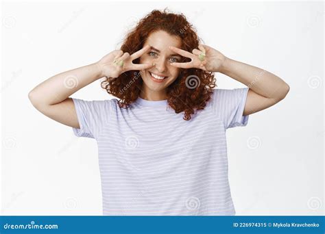 Beautiful Curly Haired Girl With Red Hair Showing Peace V Signs Near