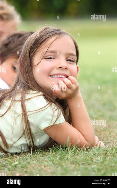 Girl Lying In The Grass Stock Photo Alamy