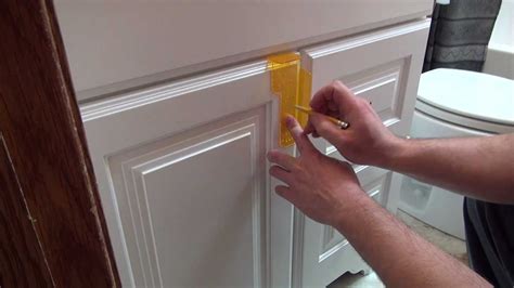 Anchor the island cabinets to the 2x2s with screws. Installing cabinet hardware - YouTube