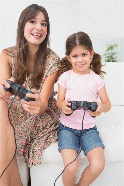 Mother And Daughter Playing Video Games — Stock Photo © Wavebreakmedia