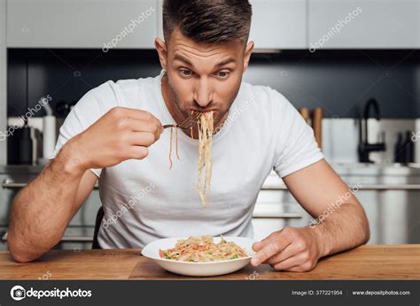 Man Eating Delicious Noodles While Sitting Kitchen Table Stock Photo By