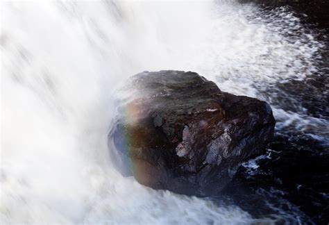 Premium Photo Rainbow Over Rock In Waterfall