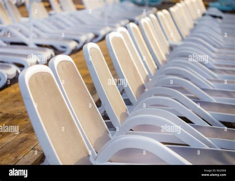Summer Morning Empty Sunny Beach With White Plastic Chairs For