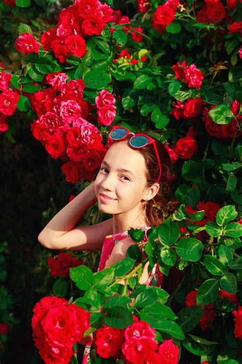 Portrait Of Cute Teenager Girl Smiling At The Roses Stock Photo Image
