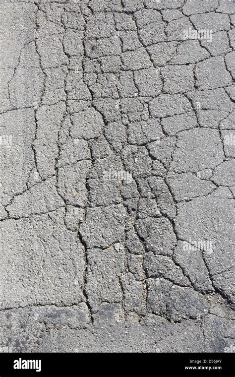 Damaged Road In Bulgaria Cracked Asphalt Blacktop With Potholes And