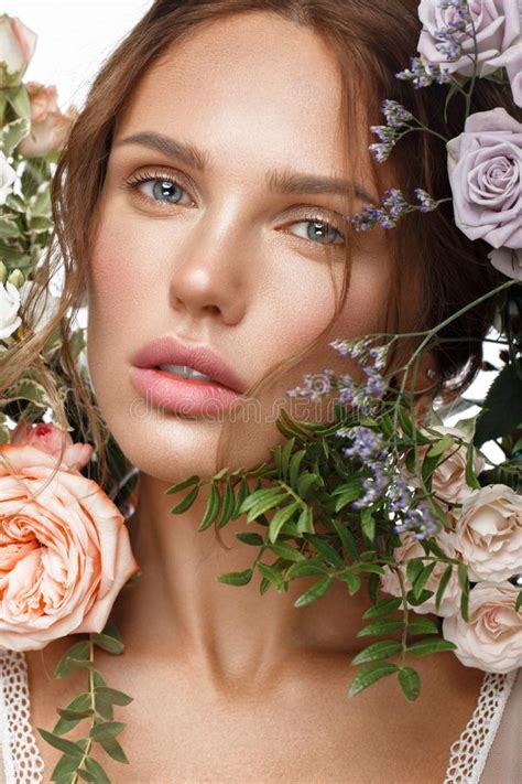 Beautiful Woman With Classic Nude Make Up Light Hairstyle And Flowers