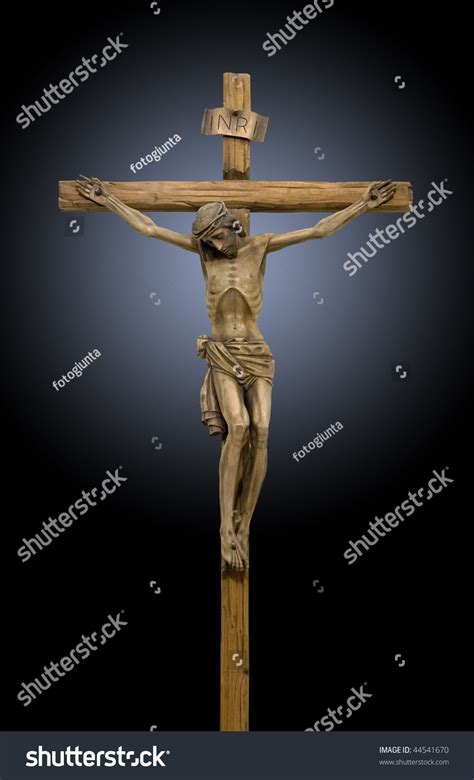 Jesus Crucified On The Cross A Wooden Statue On Black Background Stock