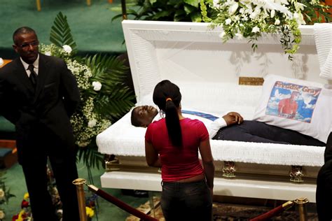 a mourner stands in front of open casket of 25 year old freddie gray during funeral service at