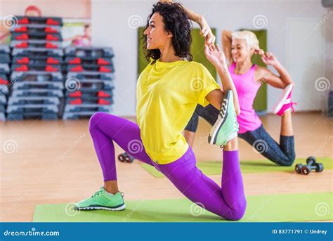 women doing stretching yoga exercises on mat indoors in gym stock image image of people